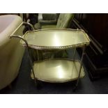 A gilt-metal drinks trolley with two removable shelves each with a pierced gallery. WE DO NOT ACCEPT
