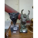 A bronze figurine of Buddha holding his hands aloft and a David Sykes bronzed head of a lioness on a