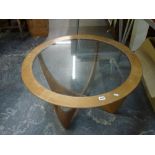 A 1960s circular coffee table with inset glass top on stylish supports, possibly by G-Plan. WE DO