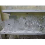 A shelf of good glassware including a comport and matching plates and trifle bowl plus dessert