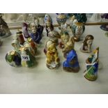An interesting collection of 26 various porcelain candle snuffers including many by Royal Doulton,