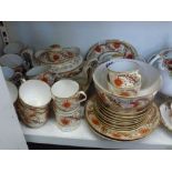 A pretty 19th century part-tea service decorated in oranges and gilt decoration including teapot and