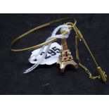 18 ct gold, comprising: an Italian bangle and tie bar, and an Eiffel Tower pendant set with red