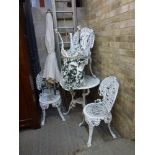 A pretty aluminium patio set comprising a small circular table of pierced decoration and four