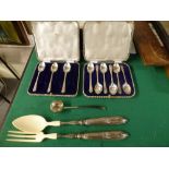 Nine silver golfing teaspoons in two cases, 3.8 ozt; a Georgian toddy ladle with indistinct marks