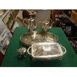 A modern silver-plated three-piece coffee service, a gallery tray, and a covered serving dish with