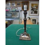 An Edwardian filled silver table candlestick, now as an electric lamp, of square section with