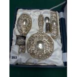 A modern filled silver reproduction dressing table set of hand mirror, hair and clothes brushes, and
