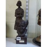A 20th century sculpture of a standing woman with baby, in heavy cast bronze, 34 cm high; and a