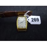 A vintage man's large wrist watch in 18 ct gold tonneau case, London import hallmark for 1928,