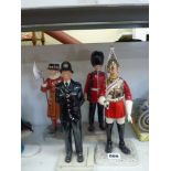 A set of four Royal Doulton iconic London figurines comprising British Policeman HN3565, Lifeguard