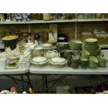 An extensive Denby table service which includes various dishes, tureens, cups, plates and mugs,