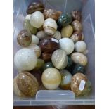 A collection of stone, onyx and other eggs plus two ceramic boule balls [on lot 892] WE DO NOT