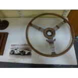 A vintage steering wheel originally owned by Sir Stirling Moss, of sprung 'banjo' type, applied with