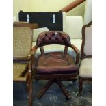 A revolving office chair upholstered in buttoned dark red leather. WE DO NOT ACCEPT CREDIT CARDS.