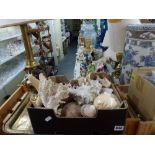 A box of decorative seashells including conches and starfish, Eastern brass tray and decorative