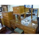 Good quality bedroom furniture in walnut comprising a serpentine dressing table with three