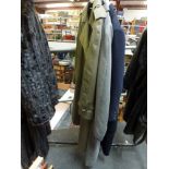 Three lady's coats comprising a Burberrys' khaki green trench coat, a grey Jaeger coat and a navy