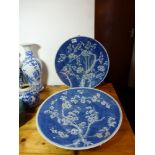 Two Chinese porcelain large blue and white dishes, each painted in blue with flowering prunus