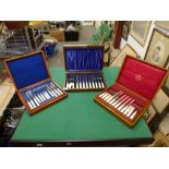 Three early 20th century wooden cases, containing: fruit eaters for 12 with mother-of-pearl handles;