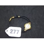 A lady's vintage wrist watch in 9 ct yellow gold, on black cordette strap with 9 ct fittings, 8.4 gm