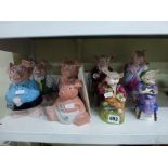 Four Wade NatWest Piggybanks and four Royal Stafford figurines of pigs comprising Mrs Pig, Mr Pig,
