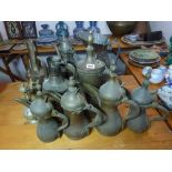 A collection of 11 various Eastern copper and brass jugs and coffee pots, mainly Arabic dallahs,