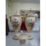 Two similar modern Royal Worcester blush ivory vases with covers, decorated with Golden Bouquet