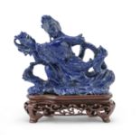 A CHINESE LAPIS LAZULI SCULPTURE DEPICTING HE XIANGU 20TH CENTURY.