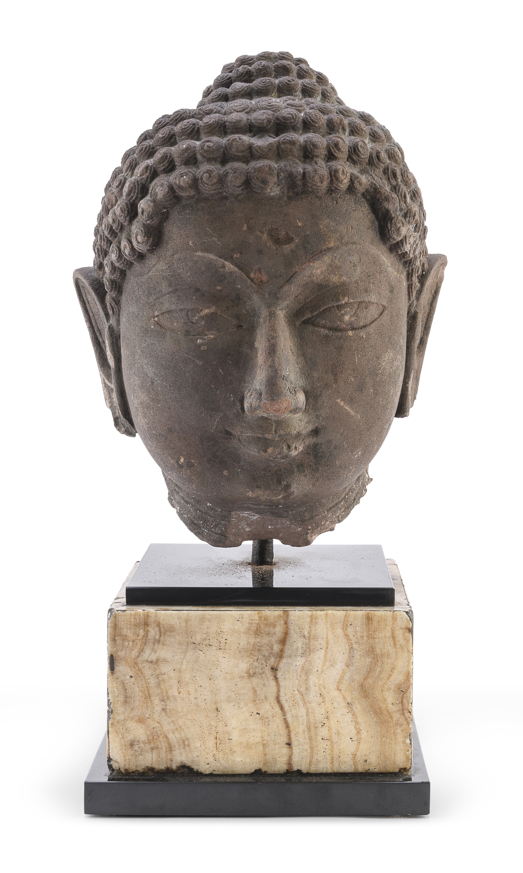 AN INDIAN SANDSTONE HEAD DEPICTING BUDDHA 10TH CENTURY.