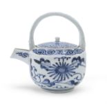 A BLUE AND WHITE PORCELAIN SAKE PITCHER DECORATED WITH KARAKUSA JAPAN FIRST HALF 18TH CENTURY