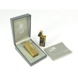 DUNHILL LIGHTERS. A 1980's Dunhill gilt metal cigarette lighter in original box with booklet.