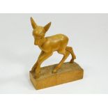 WHARTON LANG. A wood carving of a young deer. Carved signature, 'W Lang'. Max. width 15.5cm.