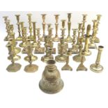 A collection of Georgian/Victorian and later brass candlesticks, many in pairs, including several