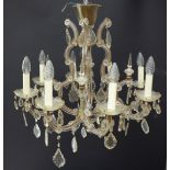 A mid / early 20th century cut glass chandelier, with eight branches fitted with drops and