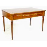 An Italian mahogany desk, circa 1970s, shaped surface above three frieze drawers, raised on turned