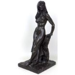 A bronzed resin sculpture, by Robert Cameron, modelled as a female nude, standing leaning against