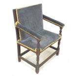 A 19th century oak armchair, of wide upright form with square back and seat upholstered in blue