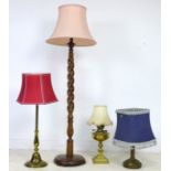 A group of three brass table lamps, with shades, together with a wooden standard lamp, 32.5 by 125cm