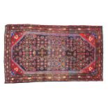 A Hamadan rug with red ground, large, highly decorative medallion to the centre, on black ground,