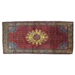 A Hamadan rug with red ground, a cream sun shaped medallion to the center on a densely decorated