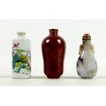 A group of three Chinese miniature bottles, comprising a carved hardstone scent bottle, 7cm high,