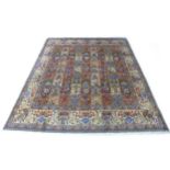 A Mood rug with compartmented foliate decoration, with two narrow pale blue borders flanking a large