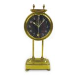 An early 20th century pillar gravity mantel clock, with visible movement behind glass dial, a/f,