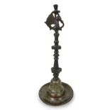 An 18th century Deccan bronze oil lamp, Indian, with Hamsa bird detail to the top, turned body