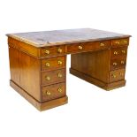 A 19th century walnut partners desk, the moulded oblong brown leather lined top above an arrangement