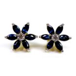 A pair of 9ct gold, sapphire and diamond flowerhead stud earrings, six petalled design formed of