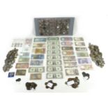 A collection of international coins and banknotes, including a sealed Banco Central de Reserva del
