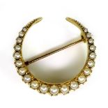 An 18ct gold and pearl crescent moon brooch, the pearls of graduated size, largest approximately 3mm