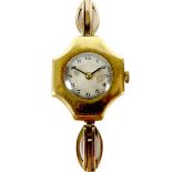 An 18ct gold cased lady's wristwatch, with cross shaped case, cream circular dial, Arabic